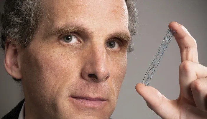 David Jones holds a vascular stent (from the Warren Anatomical Museum), designed circa 1995 by radiologist Morris Simon of Harvard Medical School.