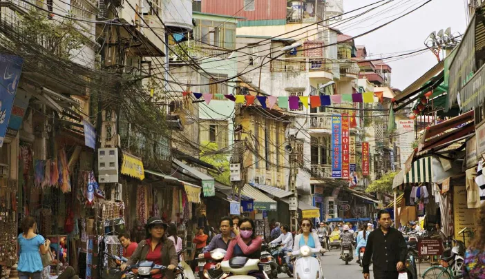 Hanoi&rsquo;s streets (in 2007, above) are now full of motorcycles and scooters, and shop shelves are no longer bare.