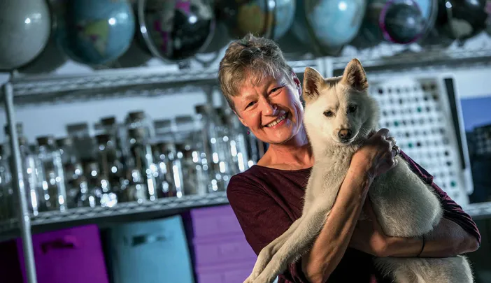 Linnea Olson, shown with her dog, Kumo, has survived 13 years with lung cancer.