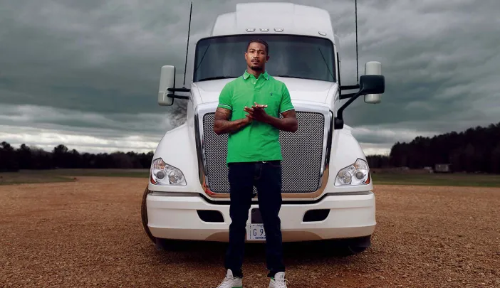 Photograph of Gary Jones standing in front of a tractor trailer truck