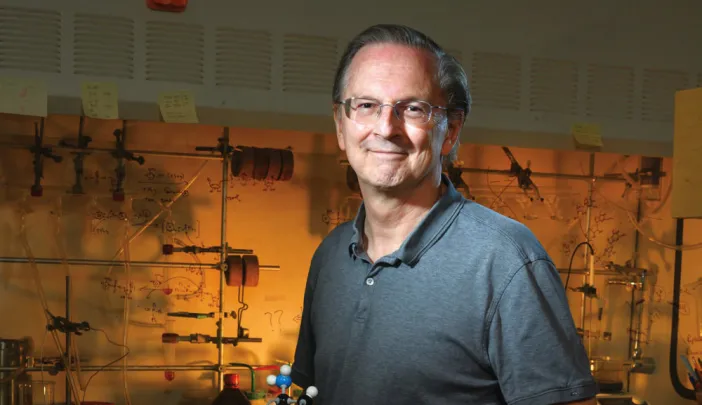Jack Szostak, in his lab at Massachusetts General Hospital, holds a model of a nucleic acid.