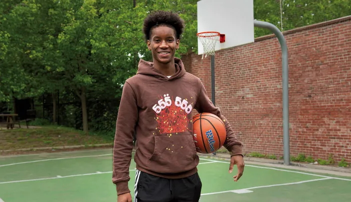 Ibrahim Barry with a basketball on a court