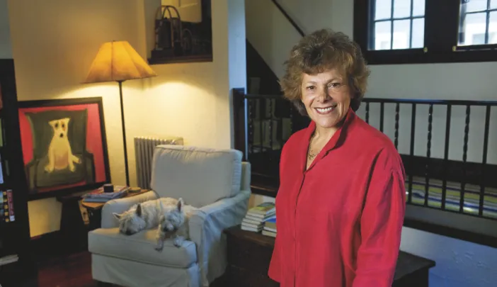 Ellen Langer at home, with her dogs and her own painting of a dog.
