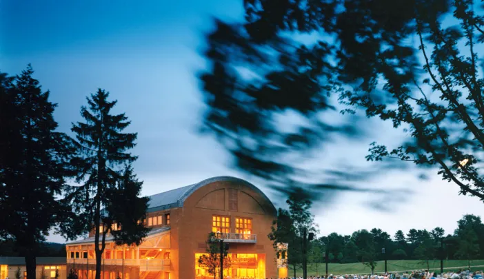 Seiji Ozawa Hall at Tanglewood, the summer home of the Boston Symphony Orchestra, in Lenox, Massachusetts. The hall opened in 1994. With the &ldquo;barn door&rdquo; open, picnickers enjoy a concert.