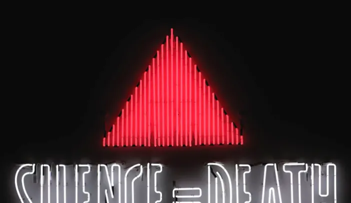 The iconic <i>Silence=Death</i> neon sign, 1987, by the Silence=Death Project, appropriated (and inverted) the pink triangle used by Nazis to identify known homosexuals; the message, in poster form, preceded the formation of ACT UP. This is a copy of the original from the collection of the New Museum, New York.