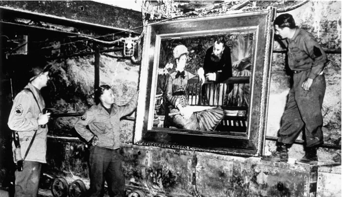 At the Merkers salt mines in central Germany, American GIs admire Édouard Manet’s <em>In the Conservatory,</em> one of the thousands of rare works and documents stored there by the Nazi regime late in World War II. Monuments Man George Stout (see next image), a Fogg Museum conservator turned U.S. Army lieutenant, supervised the rescue of 40 tons of art from the site in April 1945.