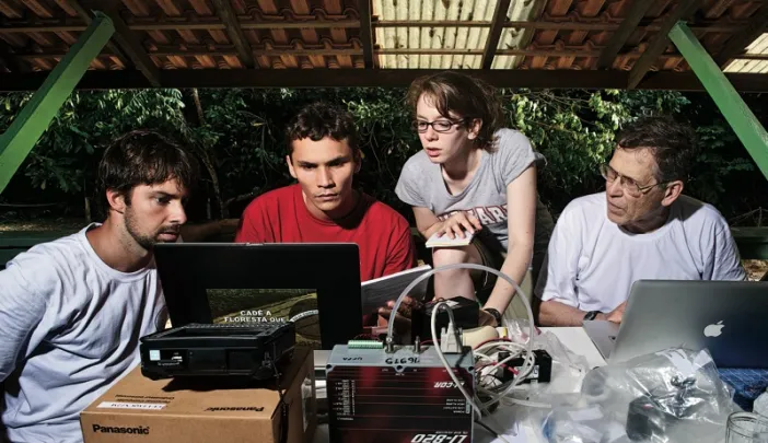 Bernardo Flores, Rafael  Tapajós, and Hannah Horowitz ’11 learn how to analyze data  gathered from a weather balloon under the supervision of  Professor Steven Wofsy