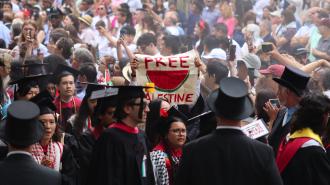 Protestors walking out of Harvard Commencement 