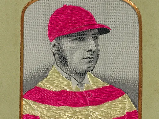 Portrait of Tom Cannon in a striped jockey uniform and matching cap.