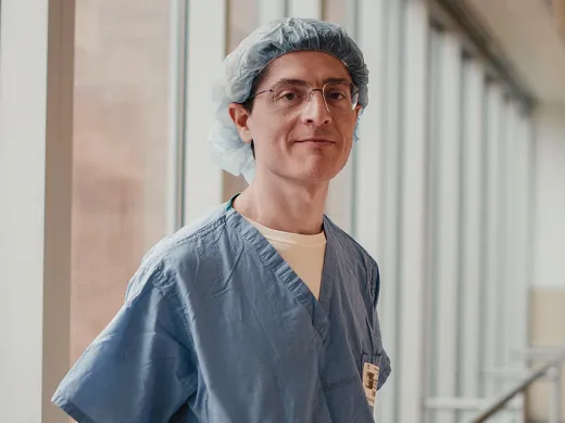 Benjamin Rapoport in surgical scrubs by a hospital window.