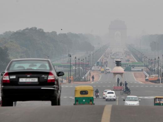 The <em>Rajpath,</em> or King’s Way, in New Delhi runs from the federal government complex to the India Gate monument (seen through morning fog in the distance). It is the route for the annual Republic Day parade.
