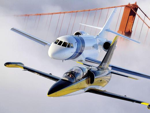 An Aero L-39 Albatros (foreground) and Dassault Falcon 2000 over the Golden Gate Bridge