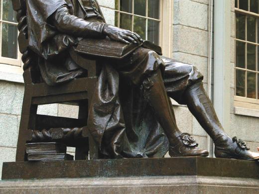 The John Harvard statue, with books at hand