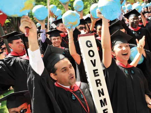 Kennedy School class marshals Asif Chishti, of Lahore, Pakistan, and Katherine Chon, of Salem, New Hampshire, both M.P.A. ’10, lead a cheer.