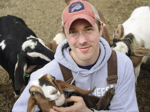 Max Sandvoss with some of his goats at the First Light Farm and Creamery in East Bethany, New York 
