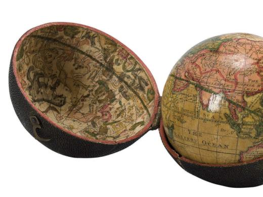 A photograph of an eighteenth-century, three-inch pocket globe in its open case