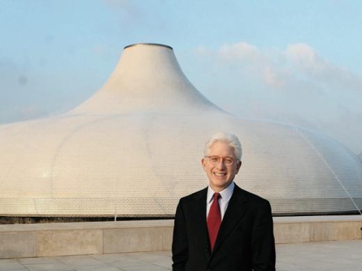 James Snyder stands in front of the exterior dome of the Israel Museum’s Shrine of the Book, which houses the Dead Sea Scrolls.