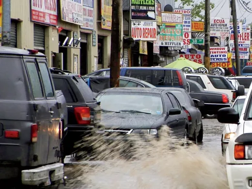 Puddles of water, a leitmotif in <i>Foreign Parts,</i> fill the rutted streets of Willets Point in Queens, a mecca for auto repair and parts.