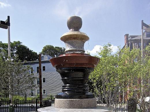 A silhouette can be seen in the negative space around the fountain at a Roxbury park.