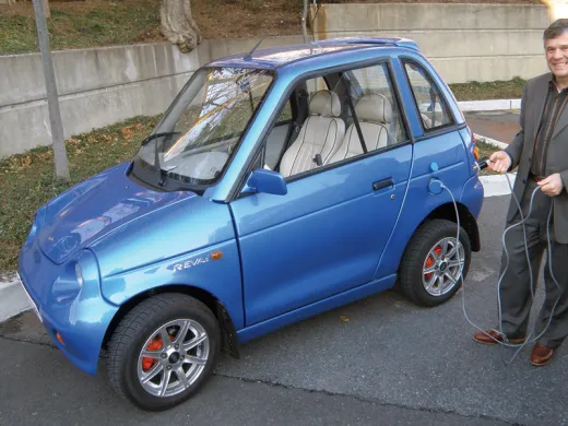 Jeffrey Leonard proudly drives a REVA electric car.