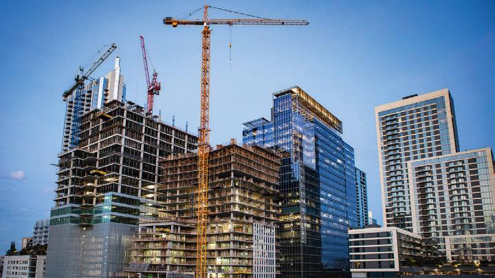 City skyline with construction of skyscrapers in the foreground