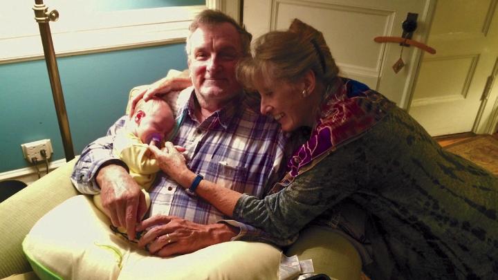 Photo of the Hrdys, author and husband, with their first grandchild