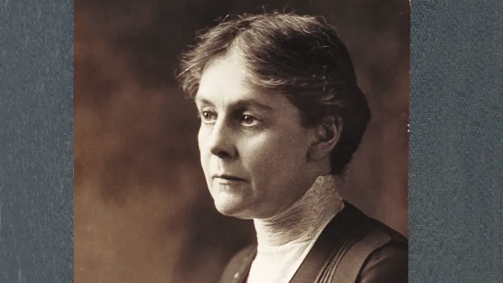 Alice Hamilton in a dark dress with high lace collar, gazing left in a sepia-toned portrait