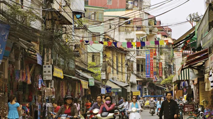 Hanoi&rsquo;s streets (in 2007, above) are now full of motorcycles and scooters, and shop shelves are no longer bare.
