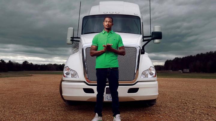 Photograph of Gary Jones standing in front of a tractor trailer truck
