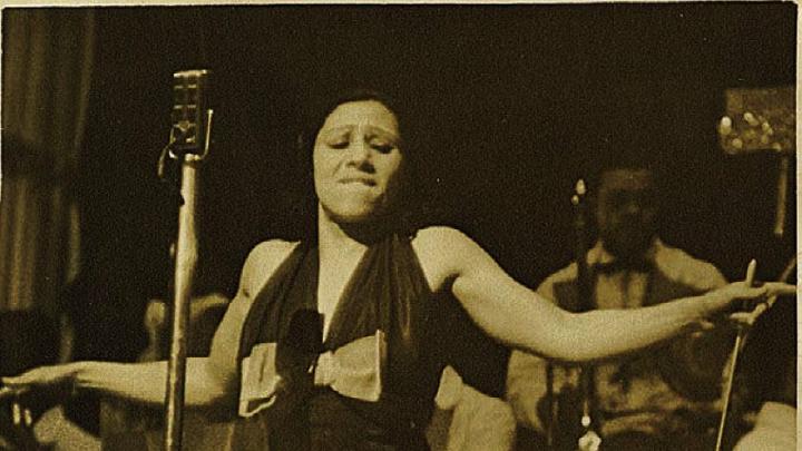 Blanche Calloway spreading her arms during a performance