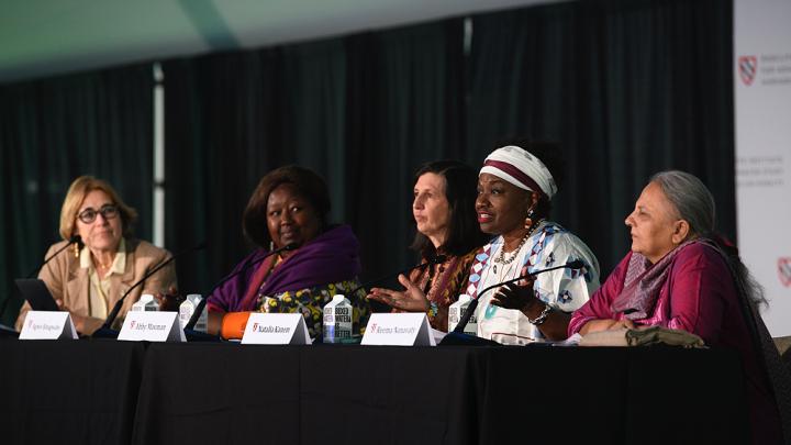 Moderator Jacqueline Bhabha seated at a table with panelists Agnes Binagwaho, Abby Maxman, Natalia Kanem, and Reema Nanavaty.