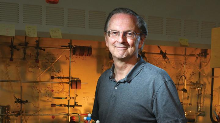 Jack Szostak, in his lab at Massachusetts General Hospital, holds a model of a nucleic acid.