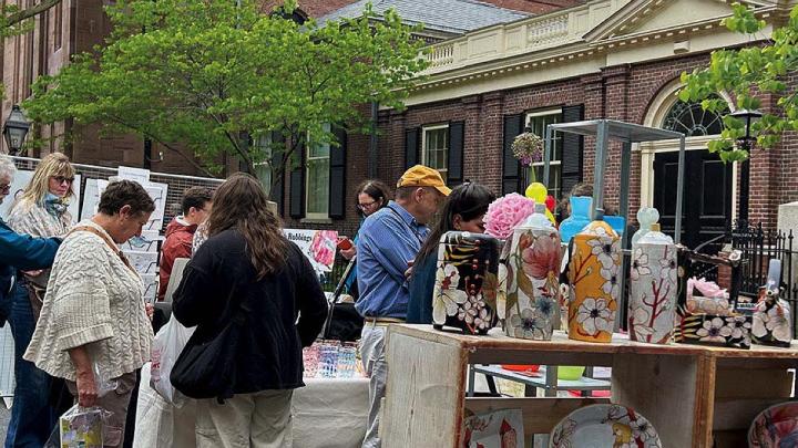 People outside at art vendors' stalls at the RISD Craft fair  