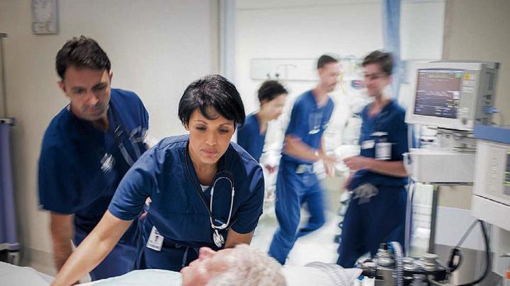 Stock photo, caring for patient in hospital bed