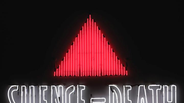 The iconic <i>Silence=Death</i> neon sign, 1987, by the Silence=Death Project, appropriated (and inverted) the pink triangle used by Nazis to identify known homosexuals; the message, in poster form, preceded the formation of ACT UP. This is a copy of the original from the collection of the New Museum, New York.