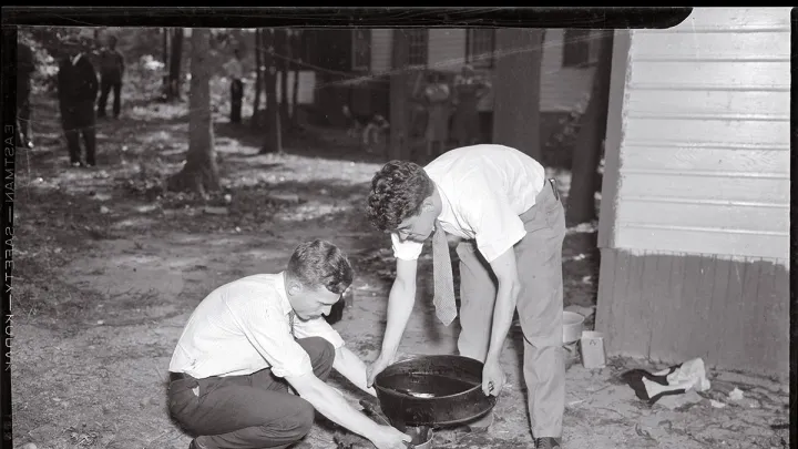 Forensic pioneer Joseph T. Walker (at left) collects blood and scraps of flesh from the bathtub drain of a 1936 murder victim.