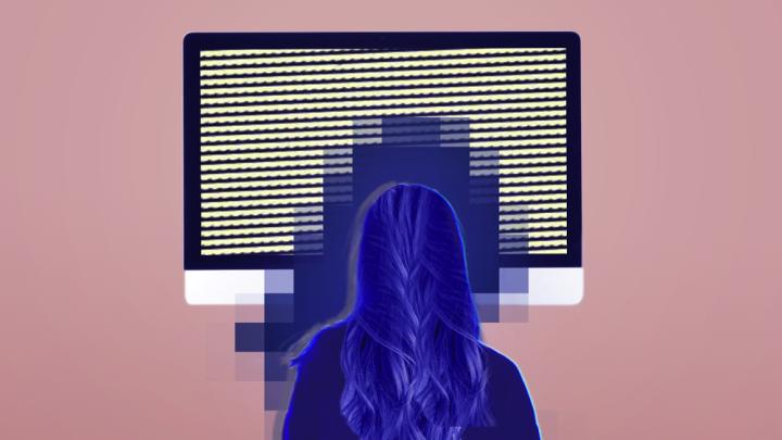 Woman sitting in front of a screen with a blue glow