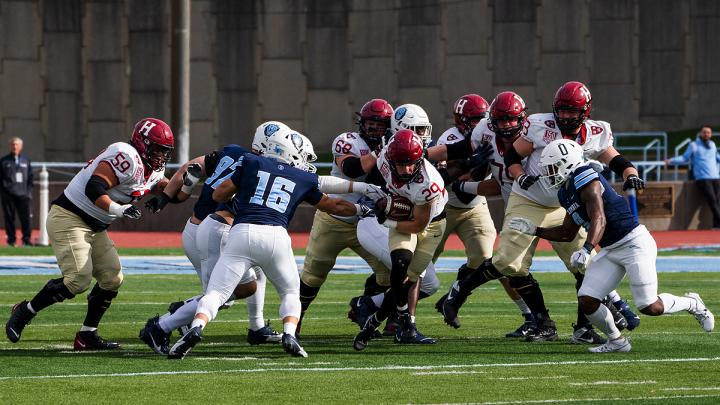 Harvard offense has the ball with Columbia defense in pursuit