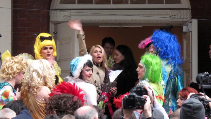 Actress Claire Danes waves to an animated crowd before entering Farkas Hall.