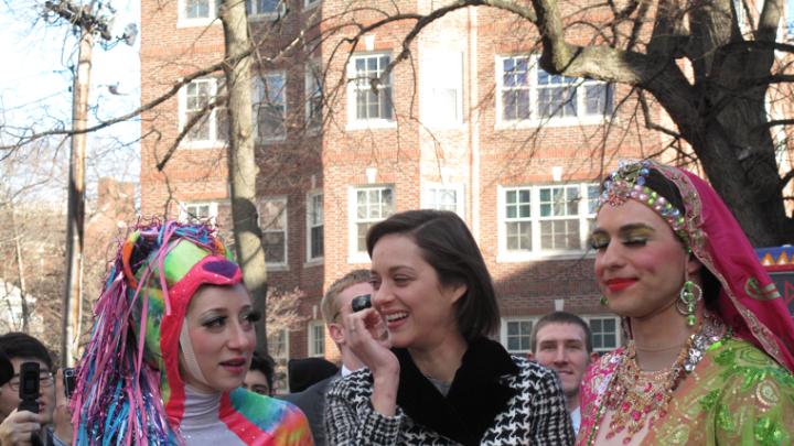 Marion Cotillard with members of the Hasty Pudding Theatricals before entering Harvard Square.