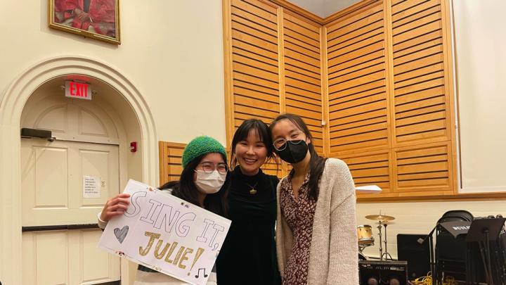 The author and two friends smiling in Holden Chapel together after her performance