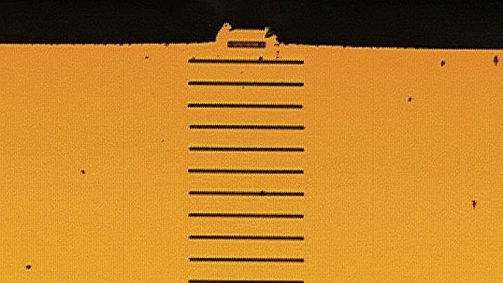 Wavelength scale grating (above) on the facet of a tiny semiconductor laser (below) creates multiple laser beams parallel to the original.