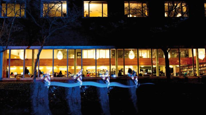 Students study for finals at night in Lamont Library, open 24 hours.