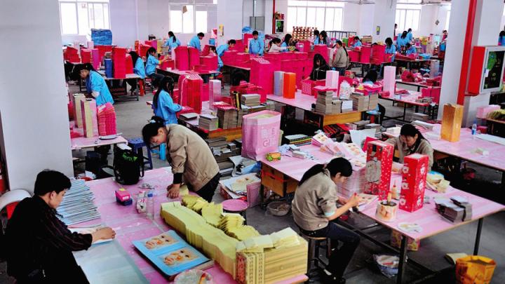 Shenzhen: leased migrant workers (in blue clothes) at a paper factory in the booming southern Special Economic Zone 