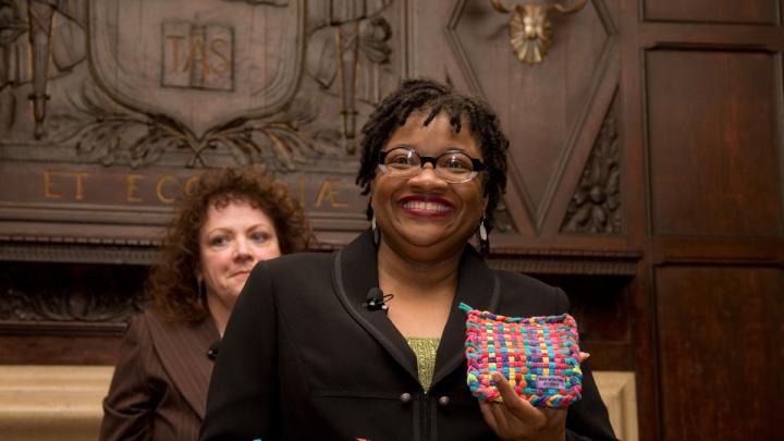 Beverly McIver with potholders made by her sister, Renée, at the Harvard Club of New York event. Filmmaker Jeanne Jordan is in the background.