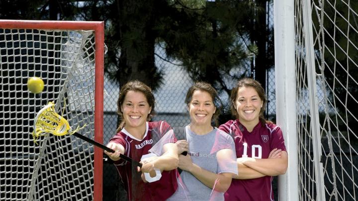 Triple image of a double threat: Baskind stands between her two sports' goals