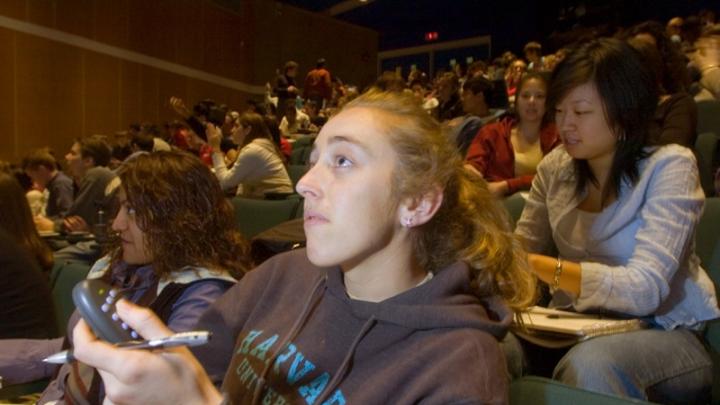 ...while Julia Pederson ’07 registers her answer with a handheld clicker...