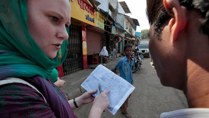A group of public-health students practiced field methods by studying sanitation in Mumbai's Cheeta Camp slum. Here, Rosemary Wyber maps the locations of toilet buildings with guidance from local residents.