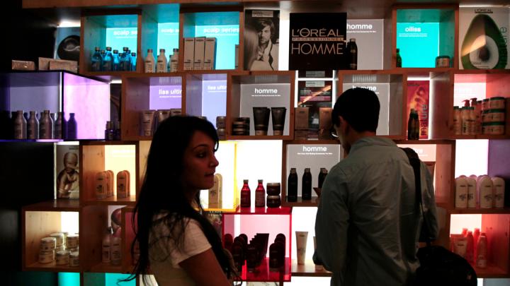 Another group advised a company on introducing a new line of hair-care products. Here, M.B.A. student Nafis Atiqullah (right) examines a product display at a hair salon. At left is Riddhi Paleja; her aunt, the Harvard students' local guide, brought her along for the day because she thought the students might find it informative to interview her. She is, her aunt said, "the only person I know who uses a lot of hair products."