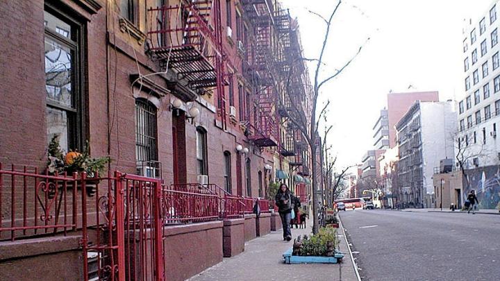 A recent photo of the Hell&rsquo;s Kitchen block on West 56th Street between Ninth and Tenth Avenues, Manhattan, where the cover of the 1957 <i>West Side Story</i> cast album (superimposed in the next image) was shot. Egan spotted the address &ldquo;418 W 56 St&rdquo; on the garbage can to the left of the heroine, Maria. 